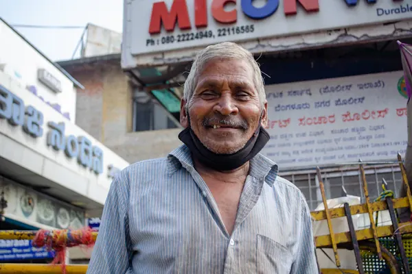 Small business owner standing in front of his shop